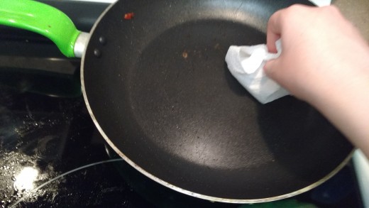 wiping grease from pan