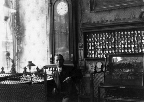 A period jeweler in his shop