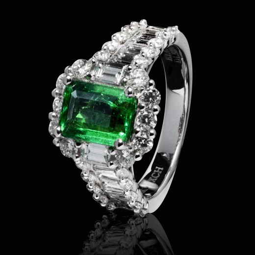 This ring contains an emerald with it's representative step cut. Diamonds cut in the same way make for a very prestigious look