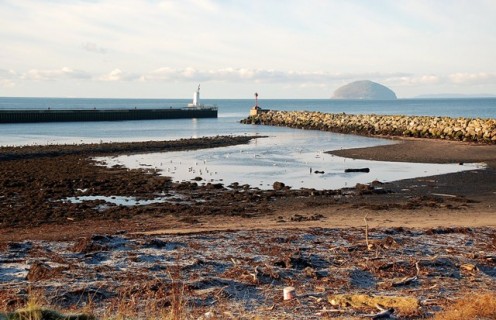 By the North Breakwater. The mouth of the Water of Girvan, viewed at low tide with Ailsa Craig in the background.