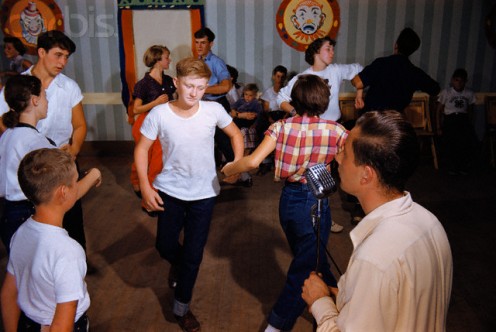 Adolescents learn the fine art of square dancing.