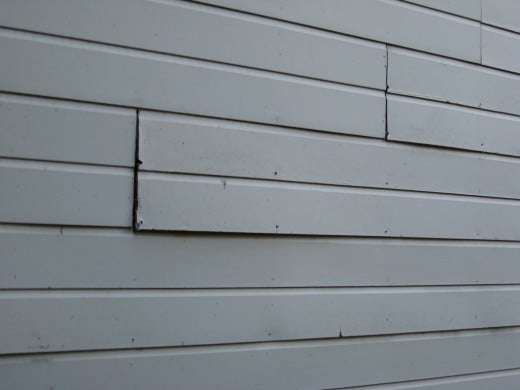 Warped, bowed out siding.
