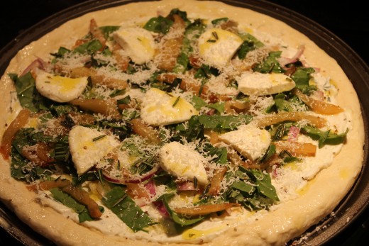 Pizza Bianche, Step Two: Top pizza with caramelized pear, thinly sliced red onion, roughly chopped baby spinach, sliced bocconcini, freshly grated parmesan cheese and drizzle with rosemary infused olive oil.