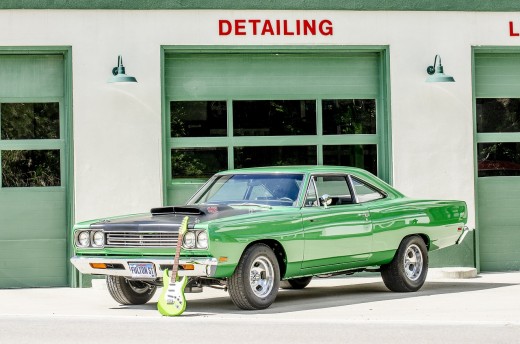 Don't get distracted by the cute green guitar because the muscle car behind it is a powerful beast of a muscle car that is so worth checking out!