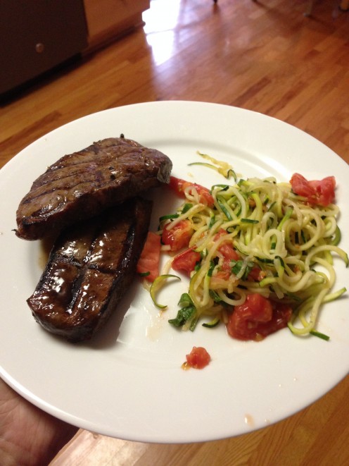 Steak and zucchini with tomatoes for dinner.