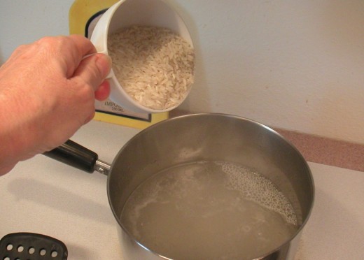 Adding the rice to the boiling water.