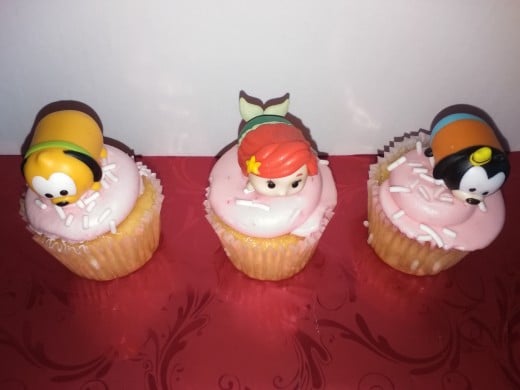 Strawberry Shortcake Mini Cupcakes topped with Ariel, Pluto and Goofy.