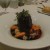 An elegant dish of short ribs surrounded by delicious veggies. An elegant dish of short ribs surrounded by delicious veggies.