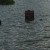 Park signs are almost buried in rising lake levels. The picnic tables are out there somewhere.