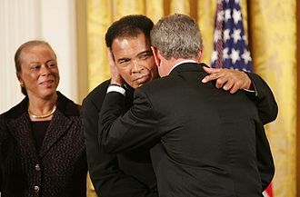Ali, his wife and President George W. Bush awarding him the medal of Honor.