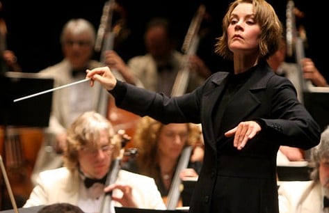 This job is more than just waving  a baton. Conductors set the music's tempo and shape the  ensemble's sound.