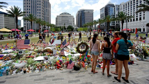 People pay their respects to an ever growing make-shift memorial at the Dr. Phillips Center for the Performing Arts, just north of the Pulse Nightclub in Orlando, Florida. 