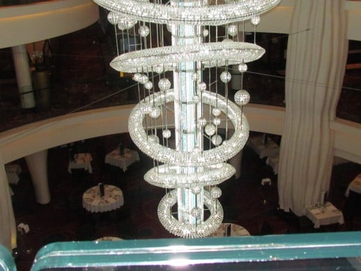 A beautiful chandelier that is in the center of the Epic Cruise Line. 