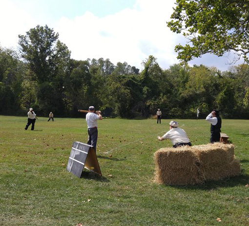 Some of the men played a baseball game in the park