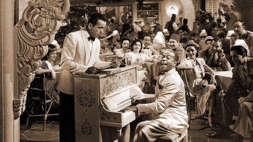 Sam is playing the piano while Rick watches him