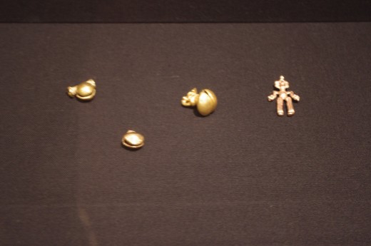 "Three Bell Pendants: Parrot, Circular, Simple" by Veraguas-Gran Chiriqui (800-1521 AD). "Pendant of a Human" Chiriqui (700-1520 AD). All made with gold-and-copper alloy (cast). These are smaller than you might think, should invest in a tighter lens.