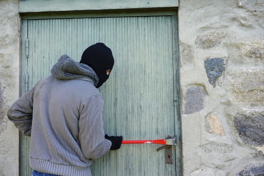 A thief committing burglary. 