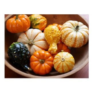 Assorted gourds and miniature pumpkins make a colorful display in a vintage wooden bowl. 