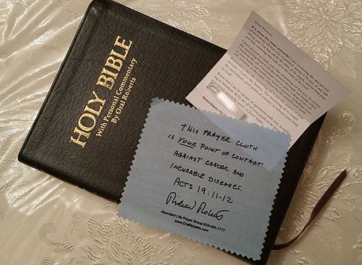 Prayer cloth and small vial of holy anointing oil attached to a card for healing.
