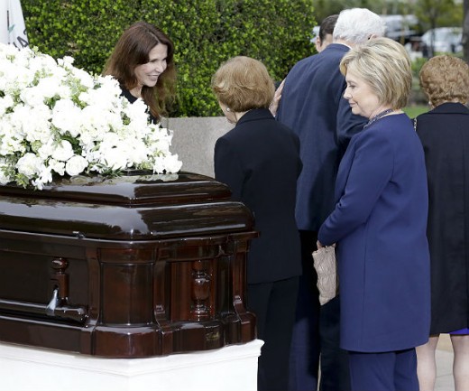 Hillary Clinton at a funeral of one of her former advisors who happened to suddenly die from unknown circumstances for unknown reasons just before he was about to release information to the media.  Notice the smile on her face.