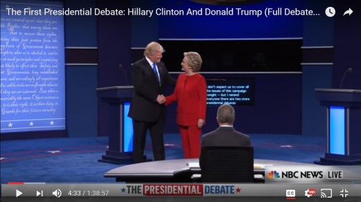 Donald Trump and Hillary Clinton shake hands.