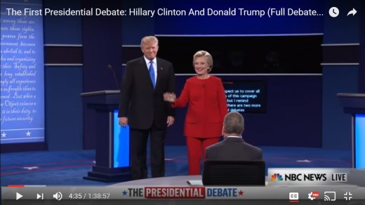 HRC begins wave toward audience. DJT stands facing audience with arms down by his side.