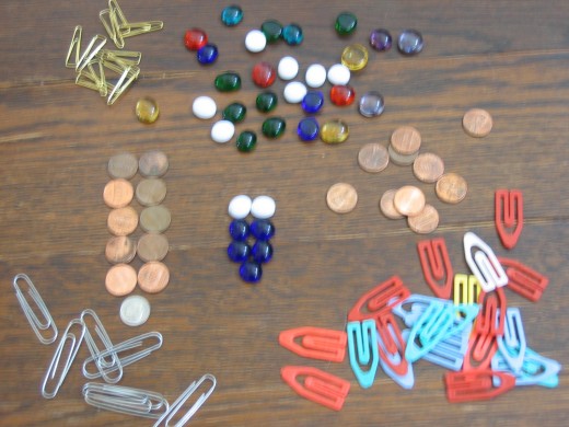 Glass beads, coins, paper clips all work great.  The game uses a lot of "markers" and "counters" and not just for tracking life points.