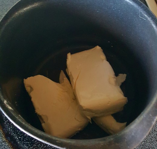 Melt cream cheese in a pot over low to medium heat.