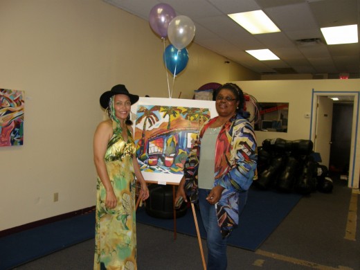 My friend, Moyaha, and I at my recent Art exhibit.  She is modeling one of my scarves from mY VIDA collection.