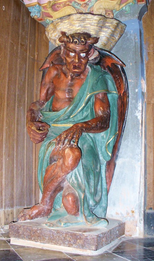 The figure of a Devil supporting the Holy Water Stoup. Rennes-le-Chateau, France 