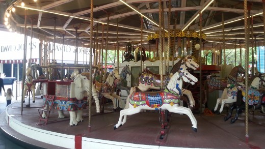 This traditional merry-go-round features an occasional elephant among the horses. Merry-go-rounds featured in sideshow alleys at the circus.