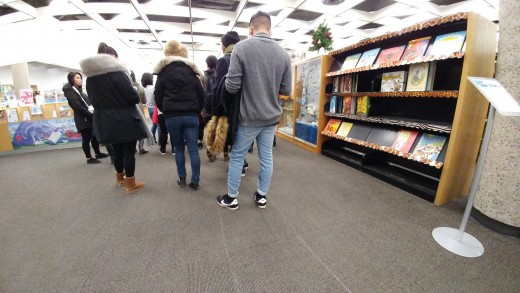 Student stayed back to use mobile phone during a library tour.