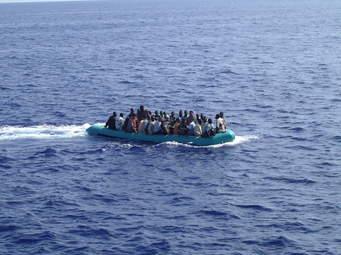 This small boat of refugees is going from Libya to Italy. They are lucky since the Sea is calm and the boat seems working well, so, they could be lucky to disembark on the coast of  Italy, with no help from the Italian Navy