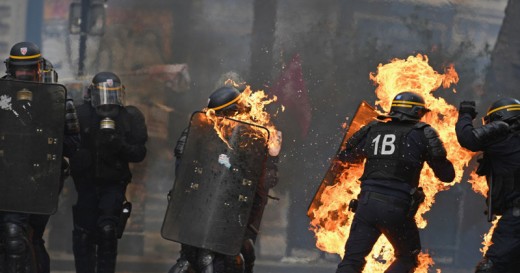 French police, set on fire by violent protestors.