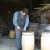 A cooper at work on a barrel in a historic village museum. 