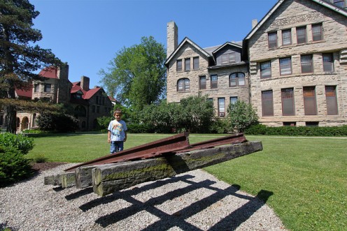 A boy called Alex at the sculpture depicting a disappearing railroad track at Shiperd Circle, Oberlin, Ohio. 