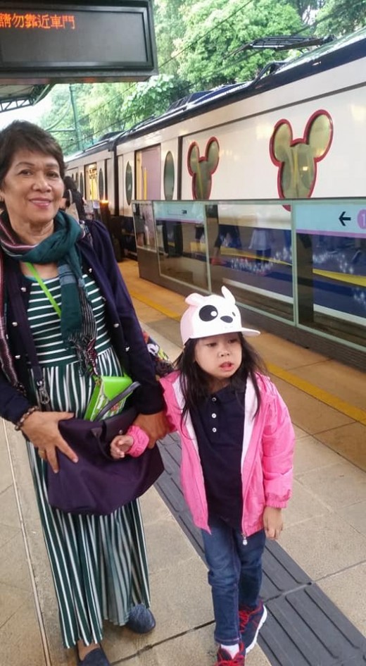 My daughter and her grandma with the train in the background