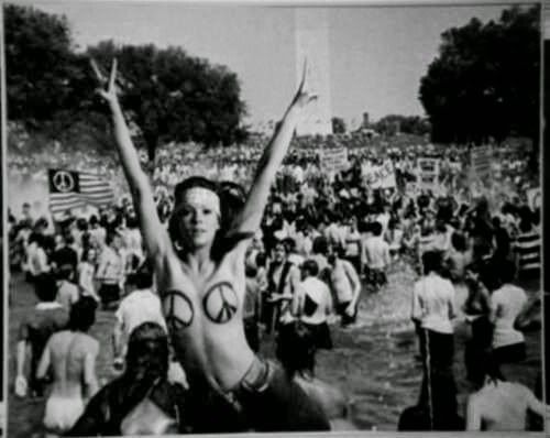 A Woodstock attendee embracing the human body through being nude. A common practice by hippies to show body positivity. 