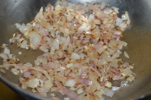 Step two: Saute cumin seeds in butter. Add chopped onions and garlic. Continue the sauteing until the onions become golden brown