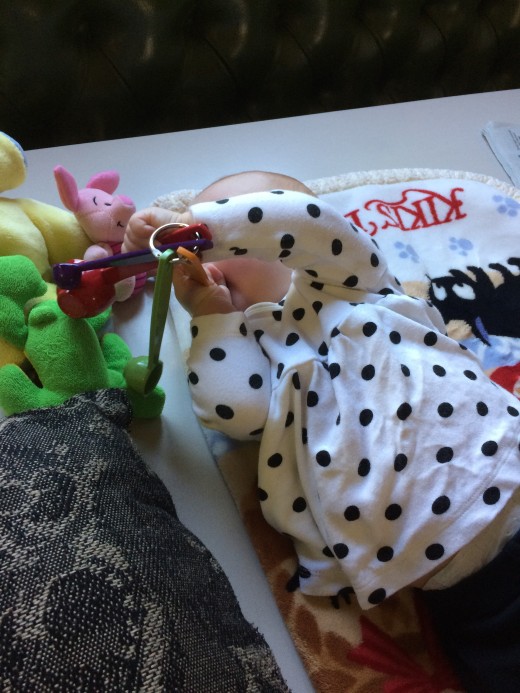 Imogen loves to shake her toys.