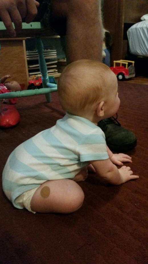 Baby begins sitting in this position, supporting herself with her hands. I encourage her by placing her hands on her thighs and spreading her feet a bit to make a broad, upright base. 