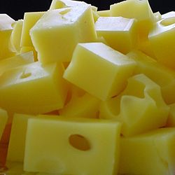 Swiss cheese is from Switzerland, and has holes in it, the bigger the "eyes" the more rich the flavor