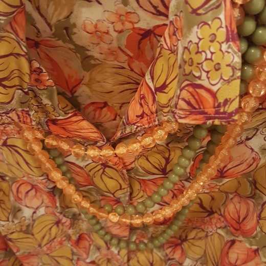 Orange print blouse and beads from "Council Thrift Shop".
