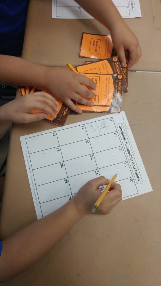 Here my students are working together during workstation rotations. They have a recording sheet to document their work.