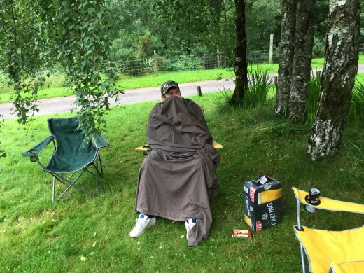 Steve is being harassed by midges and their bites. So has used a blanket to cover himself up. Midges are rampant at this time of year in Scotland.