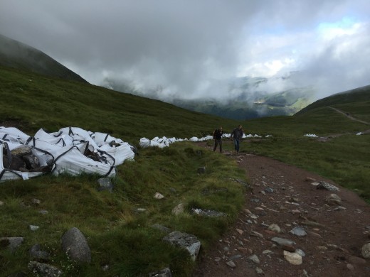 Industrial sacks laden with rocks line the side of the mountain track, these have been brought in by helicopter. The friends of Ben Nevis volunteers will use them to reinforce the track against erosion.
