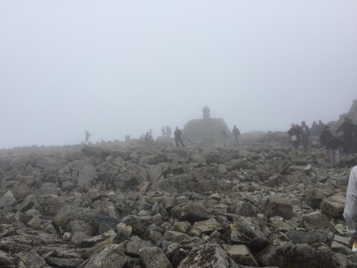 The summit trig point within view. It's a shame there is cloud cover and the vistas are obscured but at least we can see where we are putting our feet. It is quite cold here now and we have all put on top layers.