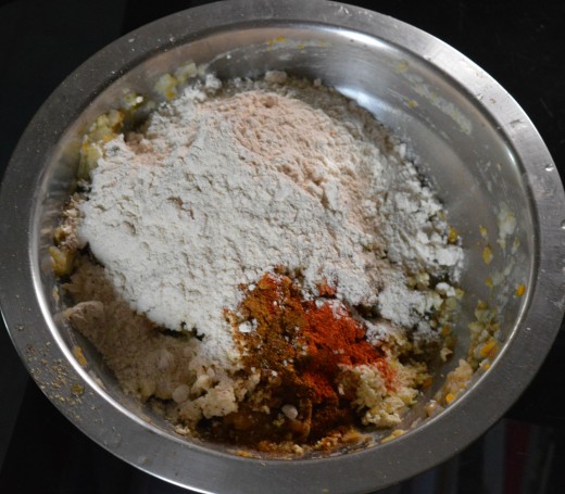 Step three: Add wheat flour, red chili powder, coriander powder, garam masala powder, oil, chopped coriander leaves, and salt.