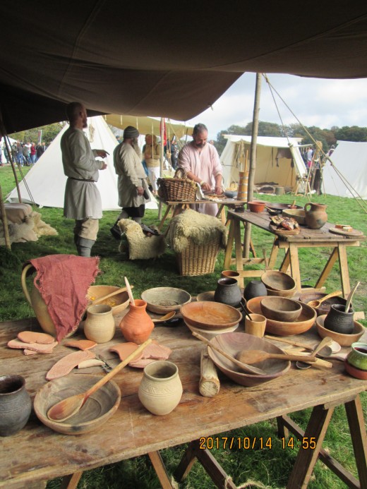 Under the awning, food and drink laid out for the returning heroes...Ceorls gather to make the camp ready to feed their lords and peers