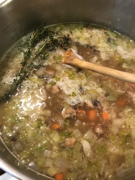 Stir in a cup of uncooked white rice, and toss in a few sprigs of fresh thyme. All it needs now is about 20 minutes to simmer, allowing the rice to cook until tender and the flavors come together.